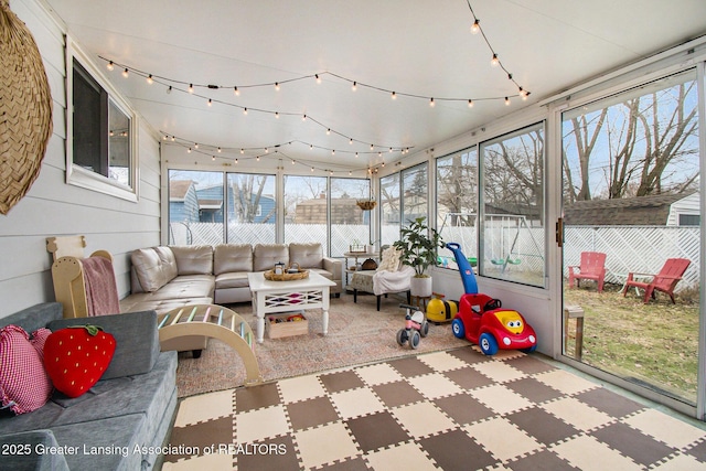 sunroom with a wealth of natural light and rail lighting