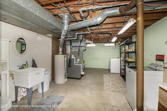 below grade area featuring heating unit, gas water heater, and washer and clothes dryer