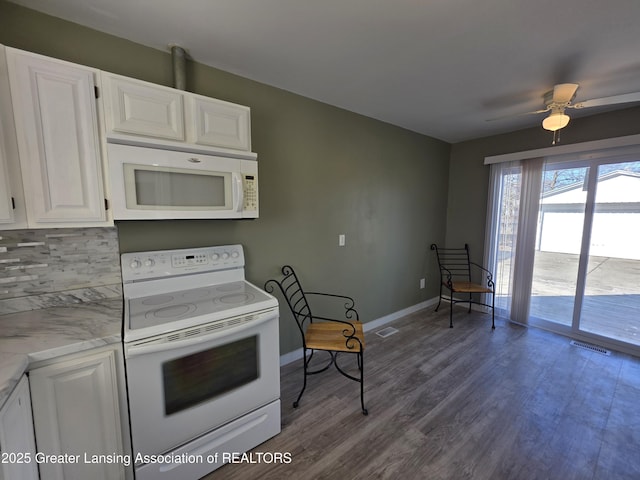 kitchen with backsplash, wood finished floors, white appliances, white cabinets, and baseboards