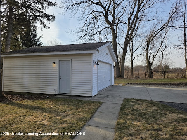 detached garage featuring fence