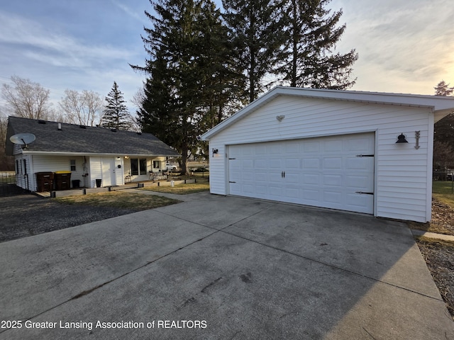 exterior space with an outbuilding and a garage