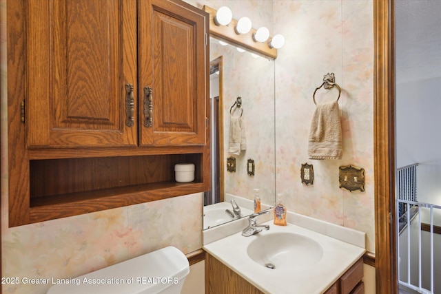 bathroom featuring toilet and vanity