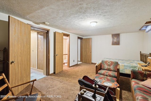 carpeted living area with baseboards and a textured ceiling