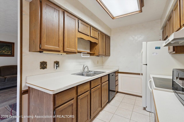 kitchen featuring light tile patterned flooring, a sink, light countertops, dishwasher, and brown cabinets