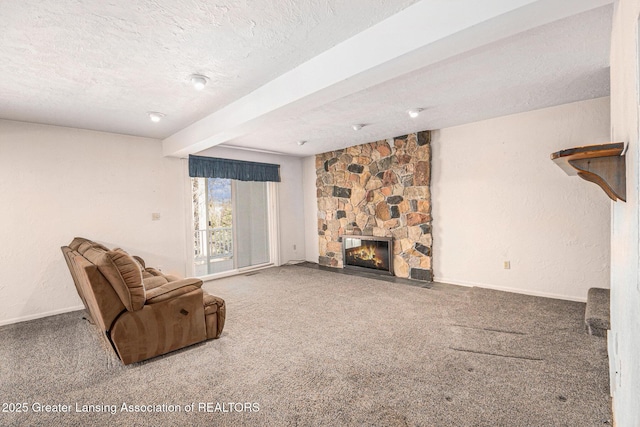 unfurnished living room featuring a stone fireplace, beamed ceiling, carpet flooring, and a textured ceiling