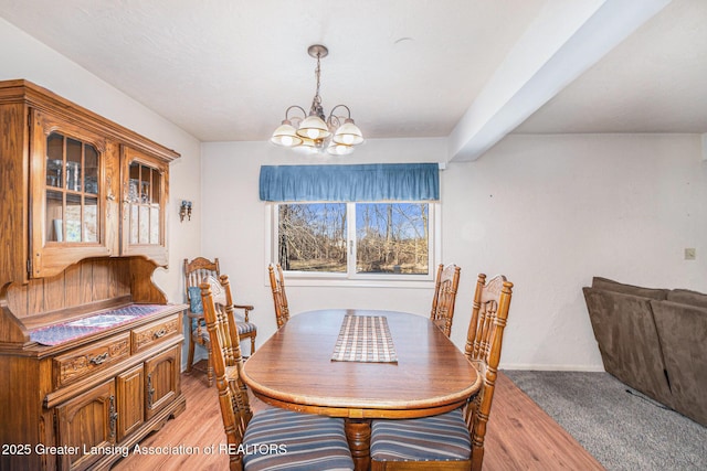 dining room with light wood-style floors and a chandelier