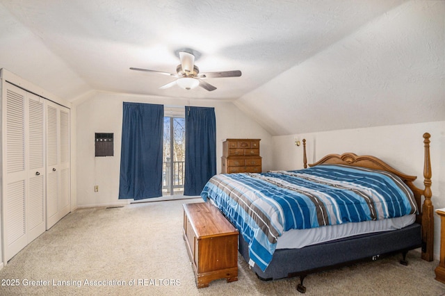 carpeted bedroom with a textured ceiling, lofted ceiling, and a ceiling fan