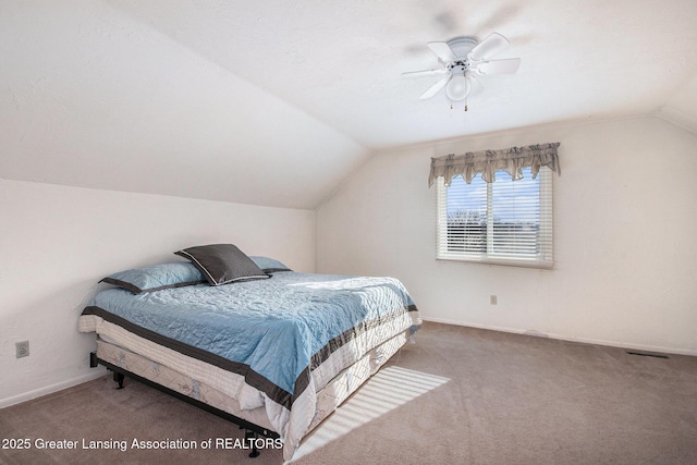 carpeted bedroom featuring ceiling fan, baseboards, and vaulted ceiling