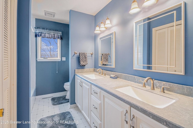 bathroom featuring toilet, visible vents, a closet, and a sink