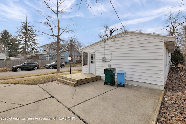 rear view of house with a patio area and fence