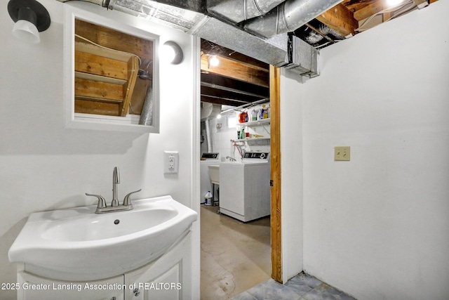 bathroom featuring vanity, washer / dryer, and concrete flooring