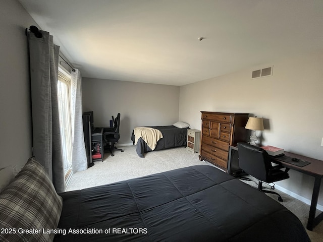 carpeted bedroom with visible vents and baseboards