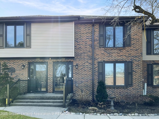 view of property with brick siding