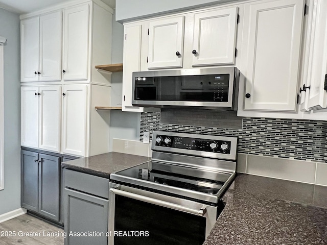 kitchen featuring open shelves, tasteful backsplash, appliances with stainless steel finishes, and white cabinetry