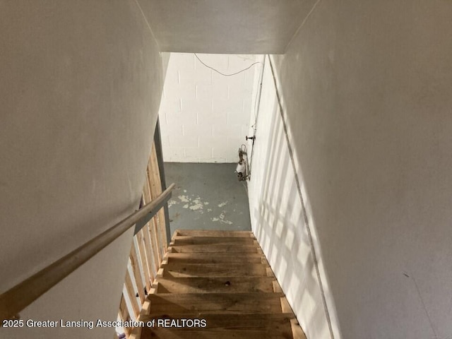 stairs with concrete block wall