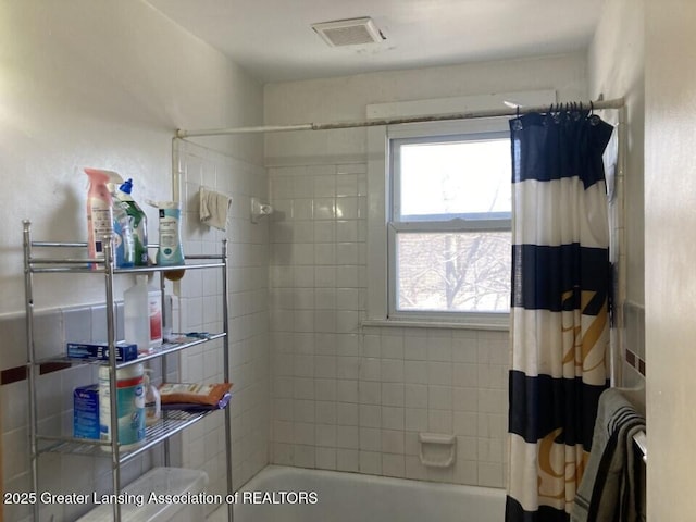 full bathroom featuring visible vents and shower / tub combo with curtain