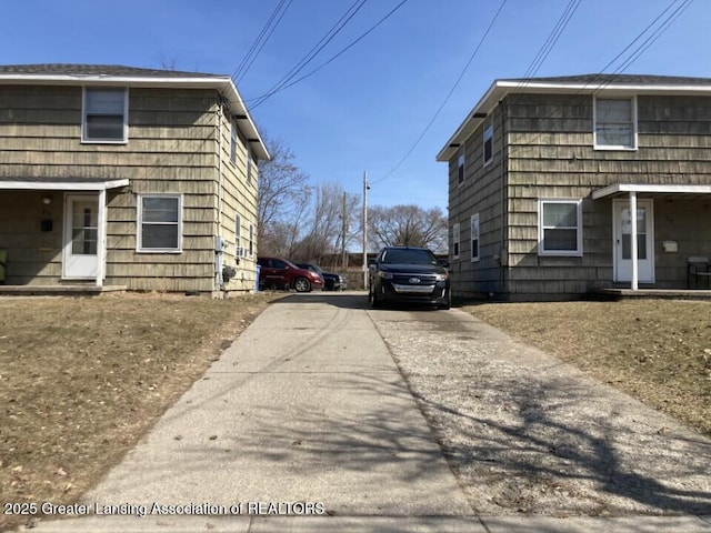 view of side of home with concrete driveway