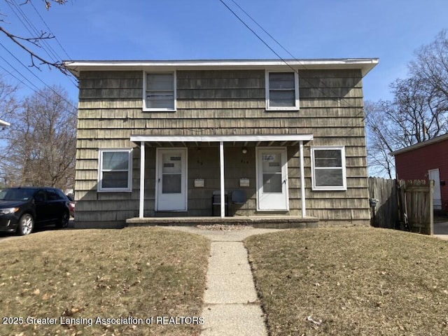 view of front of home with a porch and fence