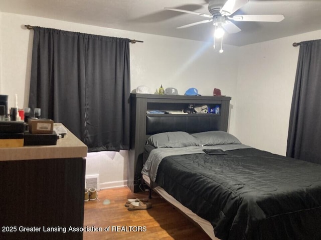 bedroom with wood finished floors and a ceiling fan