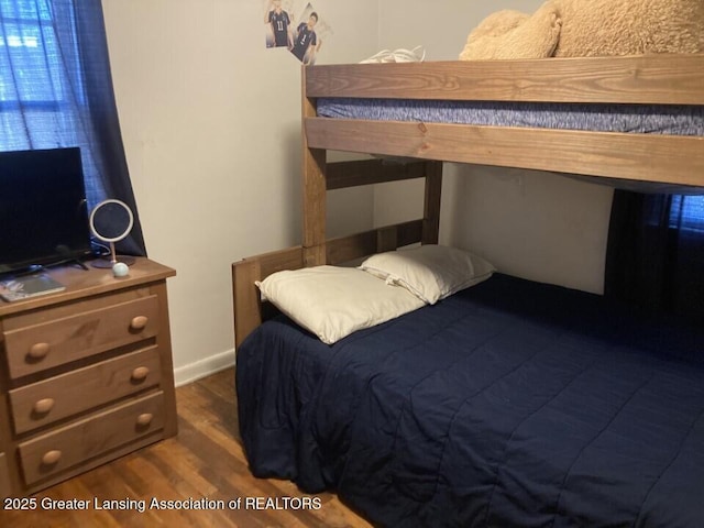 bedroom with dark wood-type flooring