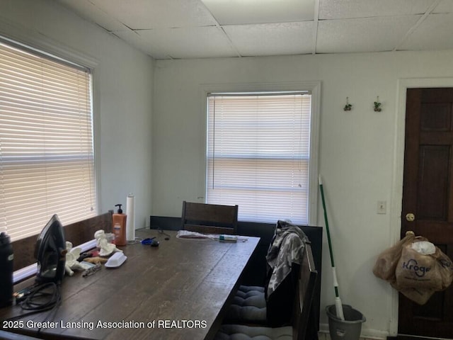 unfurnished dining area featuring a paneled ceiling