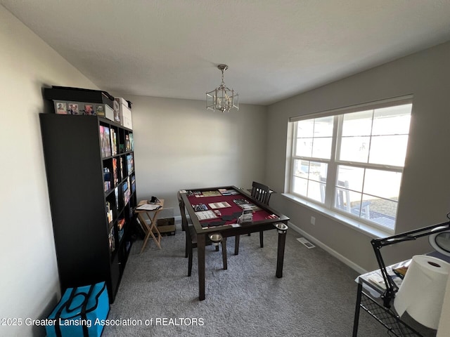 dining space with visible vents, carpet floors, baseboards, and an inviting chandelier