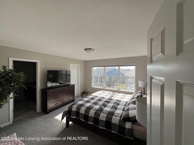 bedroom featuring carpet and a textured ceiling