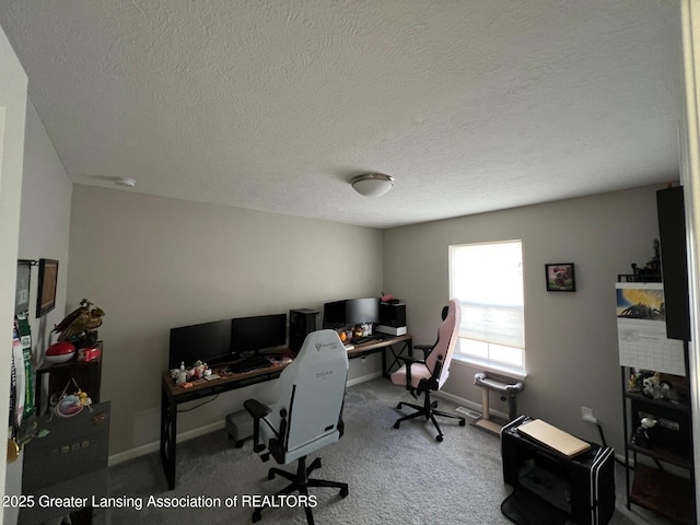 carpeted office with baseboards and a textured ceiling