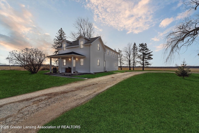 view of home's exterior featuring a lawn and driveway