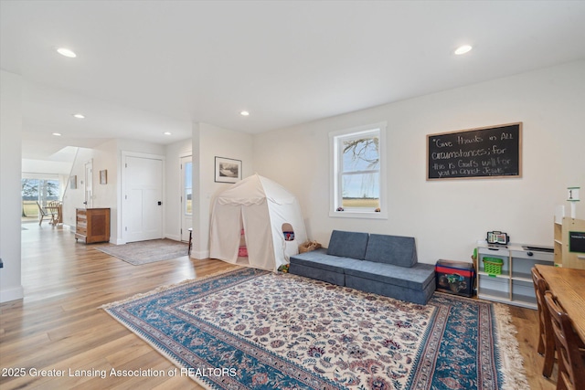 living room featuring recessed lighting, baseboards, and wood finished floors