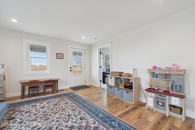 interior space with recessed lighting, baseboards, and wood finished floors