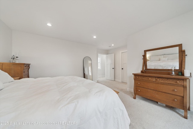 bedroom with recessed lighting, light colored carpet, and baseboards