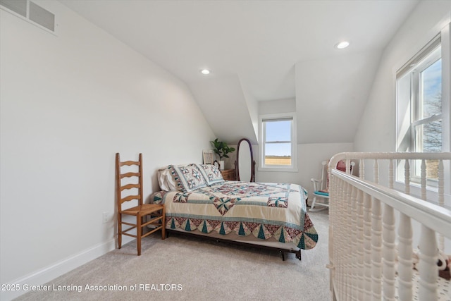 bedroom featuring visible vents, carpet floors, baseboards, and vaulted ceiling