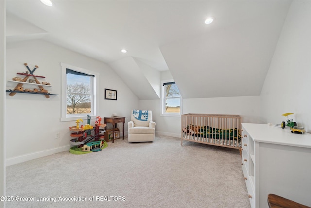 carpeted bedroom with a crib, lofted ceiling, recessed lighting, and baseboards