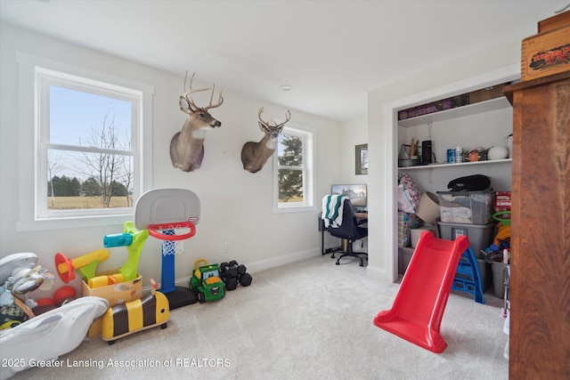 playroom featuring baseboards and carpet flooring