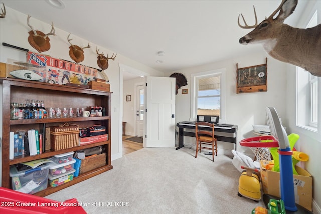 rec room with carpet flooring and plenty of natural light