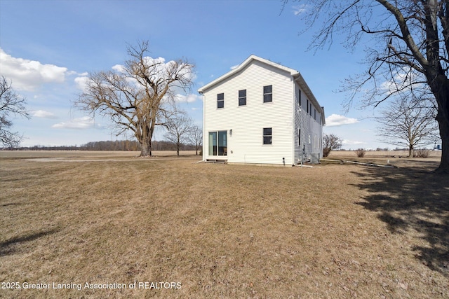 back of house with a lawn