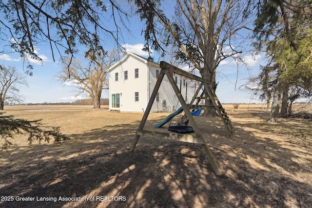 back of house with a playground