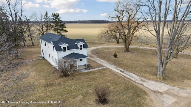 birds eye view of property with a rural view