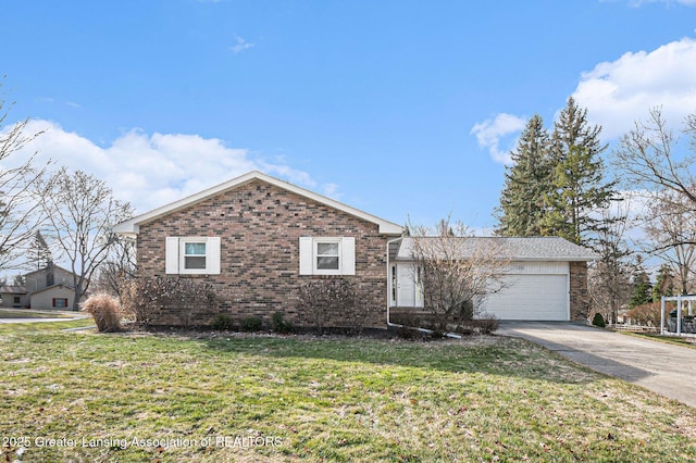 single story home featuring a garage, a front lawn, brick siding, and driveway