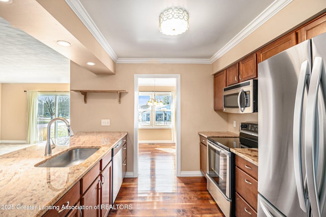 kitchen with a sink, crown molding, brown cabinets, appliances with stainless steel finishes, and open shelves