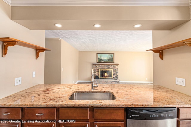 kitchen with open shelves, light stone countertops, dishwasher, and a sink