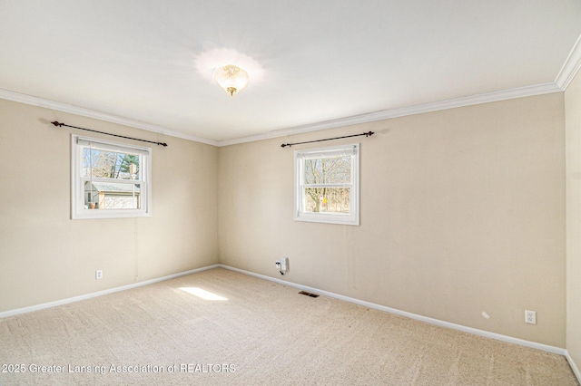 carpeted empty room featuring a wealth of natural light, baseboards, and ornamental molding