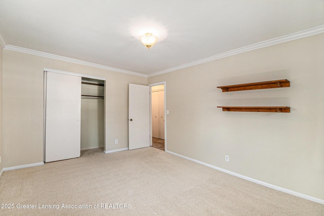 unfurnished bedroom featuring a closet, crown molding, baseboards, and carpet floors