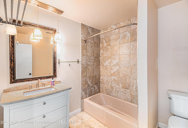 bathroom with vanity, baseboards, bathing tub / shower combination, toilet, and tile patterned floors