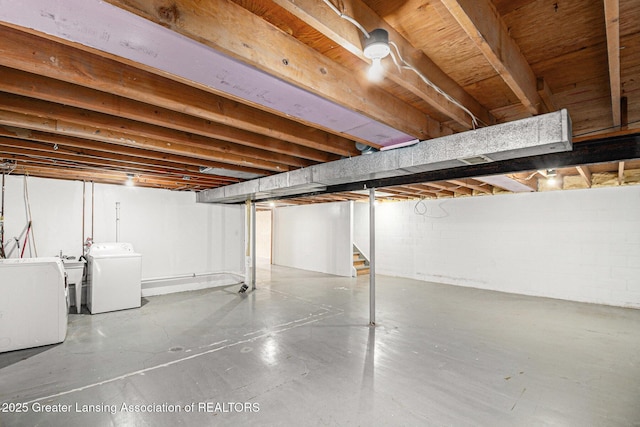 unfinished basement featuring washing machine and dryer