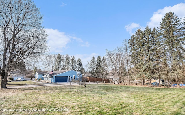 view of yard with a garage and fence