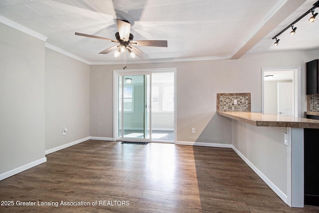 unfurnished room with crown molding, baseboards, dark wood-type flooring, and ceiling fan