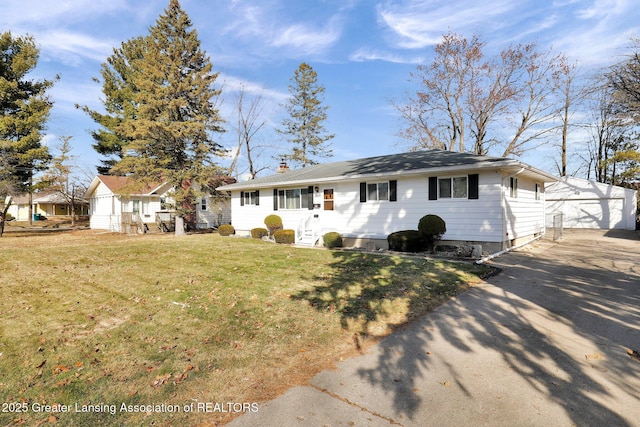 ranch-style home featuring a front lawn, entry steps, a detached garage, an outdoor structure, and a chimney