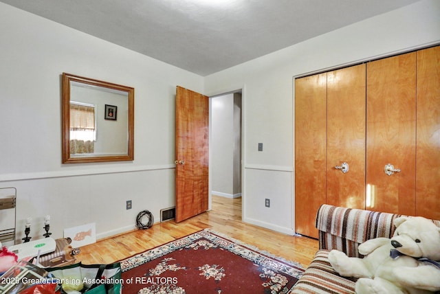 interior space with visible vents, baseboards, and light wood-style flooring